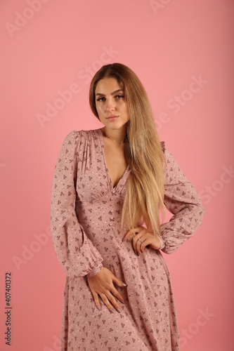 Young woman in dress on pink background © Сергей Луговский