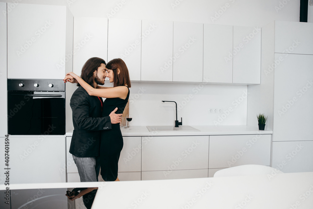 A loving couple hugs tenderly in a cozy home environment A loving couple hugs tenderly in a cozy home environment