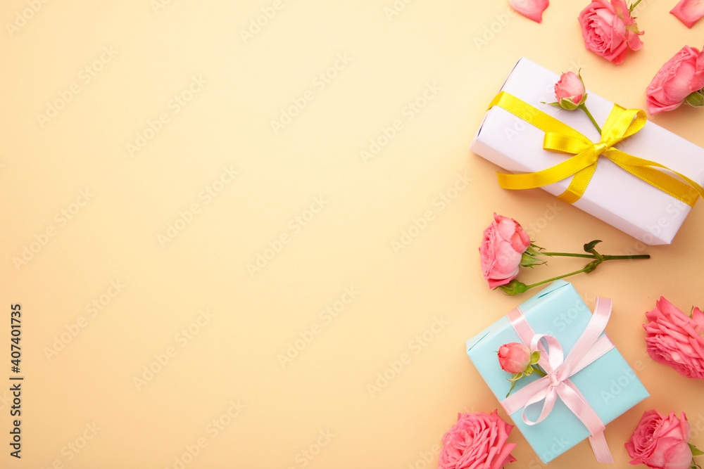 Valentines day background with pink roses and gift box on beige background. Top view. Valentines day background with pink roses and gift box on beige background. Top view.