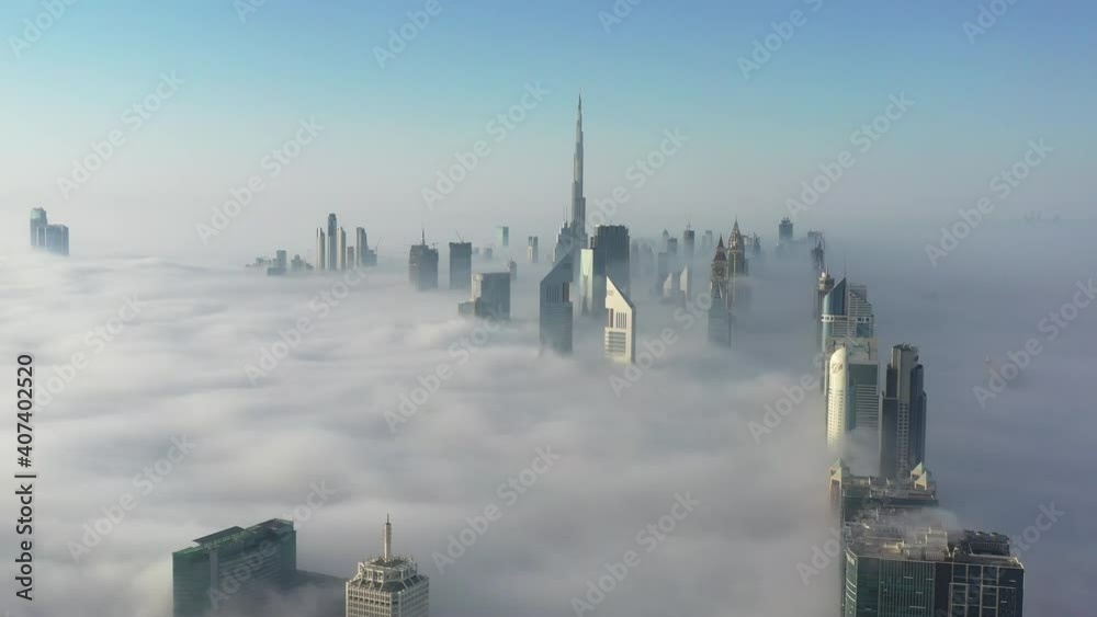 Aerial birds eye view of Dubai futuristic urban city skyline during fog