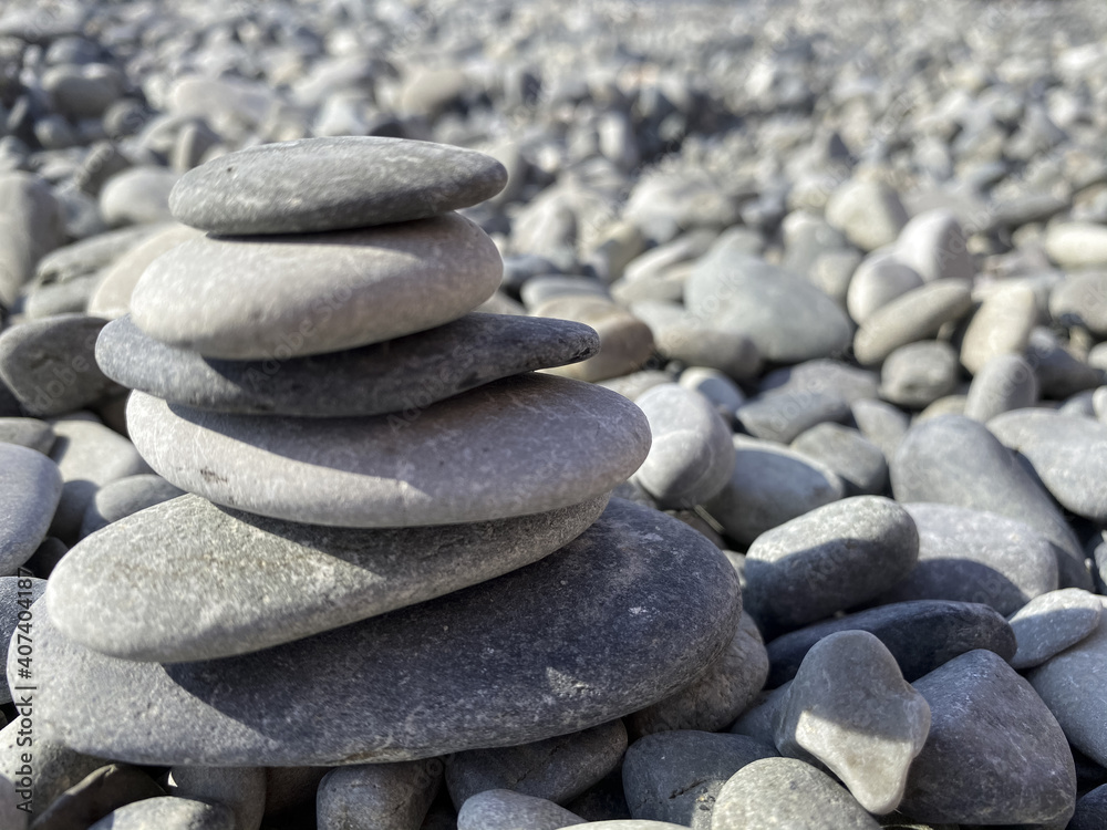 Nice abstract background pattern with large gray pebble sea stones. Pyramid of stones Nice abstract background pattern with large gray pebble sea stones. Pyramid of stones