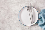 empty plate fork knife on concrete background