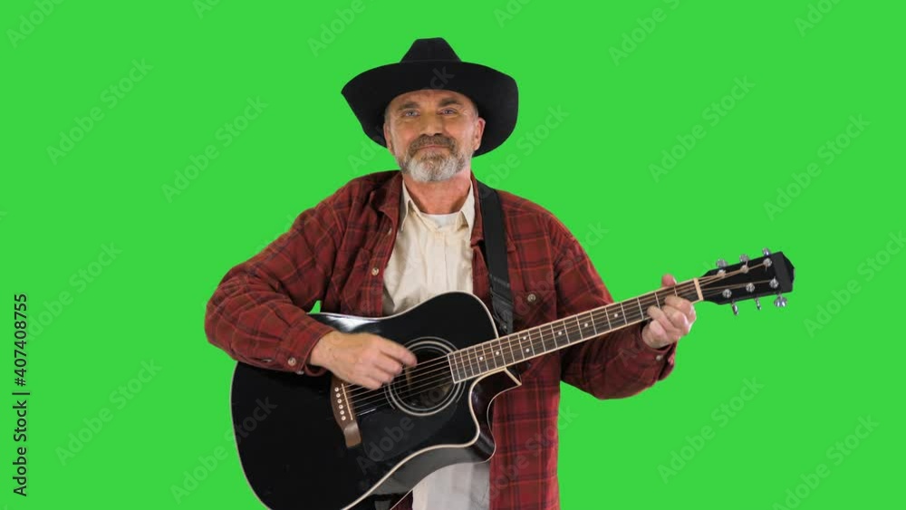 Senior man walking and playing country music on a Green Screen, Chroma Key. Senior man walking and playing country music on a Green Screen, Chroma Key.