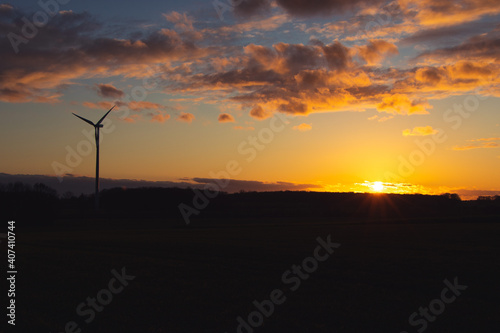 Black Silhouette of windturbines energy generator on amazing sunset at a wind farm in langenberg, germany