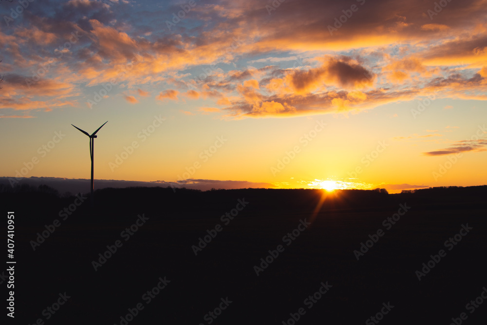 Black Silhouette of windturbines energy generator on amazing sunset at a wind farm in langenberg, germany Black Silhouette of windturbines energy generator on amazing sunset at a wind farm in langenberg, germany