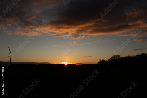 Black Silhouette of windturbines energy generator on amazing sunset at a wind farm in langenberg, germany