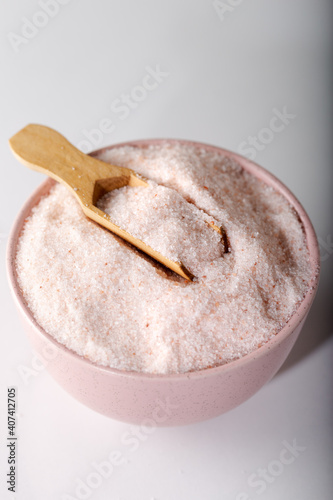 Powder Himalayan pink salt in measuring cup. Food background.