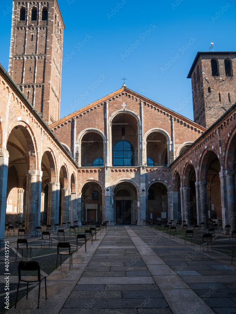 Milan, Italy - December 26, 2020: Atrium of Ansperto in the Sant'Ambrogio basilica with spaced chairs for security