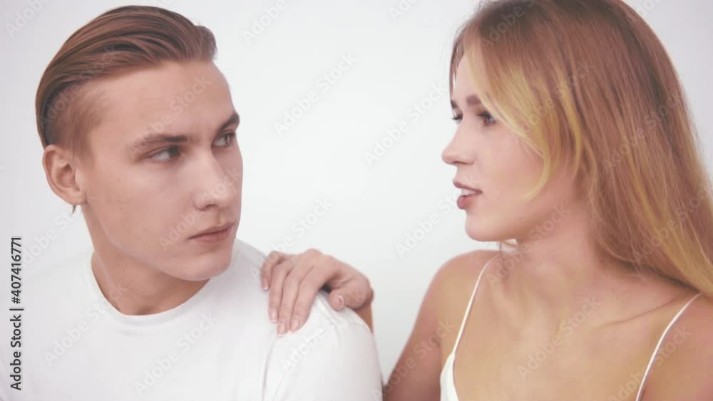 Young people look at each other with furrowed brows Young people look at each other with furrowed brows