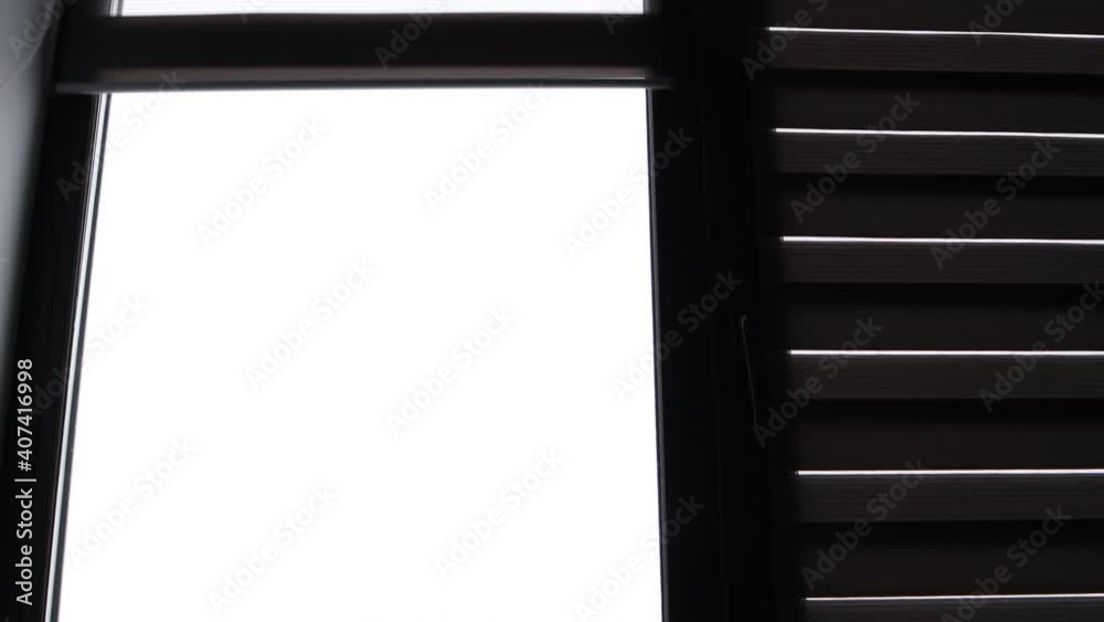 The roller shutters rise and open the window The roller shutters rise and open the window