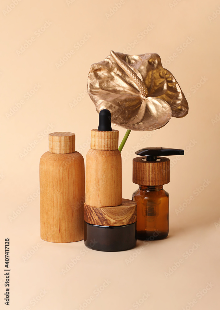 Beautiful composition in pastel colors from the cosmetics bottles and golden flamingo flower.Wooden,zero waste containers.Photography with copy space,good for advertising.Vertical orientation. Beautiful composition in pastel colors from the cosmetics bottles and golden flamingo flower.Wooden,zero waste containers.Photography with copy space,good for advertising.Vertical orientation.