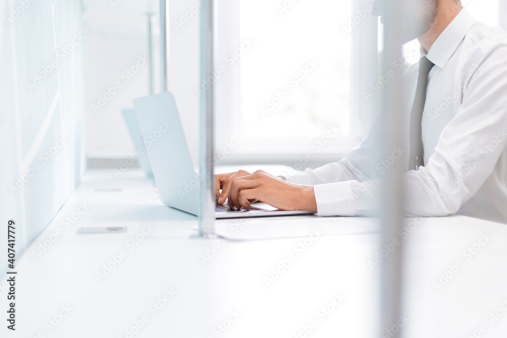 background image of a business man working on an office laptop . background image of a business man working on an office laptop .