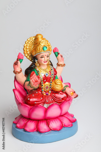 Beautiful Clay Idol of Hindu Goddess Lakshmi OR Laxmi on white background