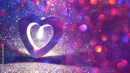 Romantic background for Valentine s Day. Garland in the shape of a heart close up on a shiny surface  bokeh