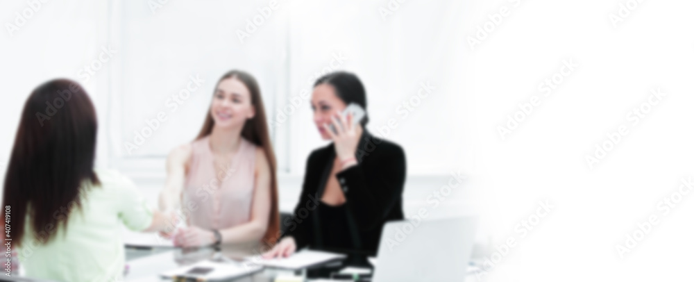 handshake of young business partners at a working meeting in the office handshake of young business partners at a working meeting in the office