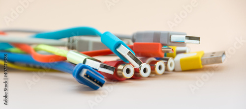 Multicolored electrical wire and cable used in communication cable network and computer system on light background.