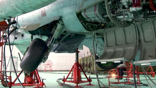 Vintage video from archive. Military attack aircraft. Sukhoi Su-25 attack aircraft (NATO codification: Frogfoot) is installed on hydraulic lifts. Checking performance of front and main landing gear.
 photo