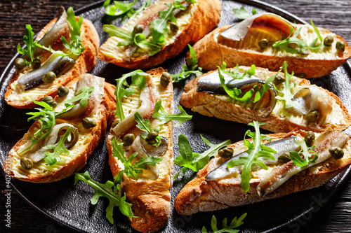Obraz na płótnie anchovy butter sandwiches with capers and arugula