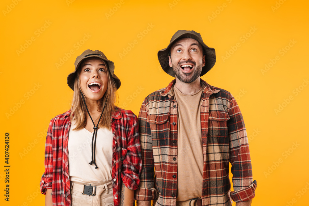 Beautiful excited couple exclaiming and looking upward Beautiful excited couple exclaiming and looking upward