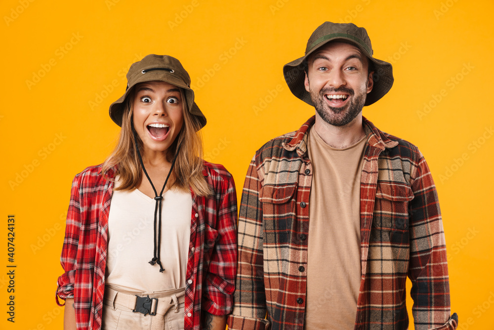 Fototapeta premium Beautiful excited couple exclaiming and looking at camera