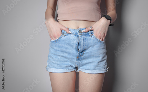  Woman in fashion blue jeans shorts.