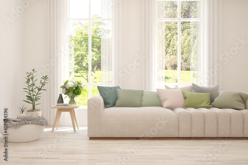 White living room with sofa and summer landscape in window. Scandinavian interior design. 3D illustration