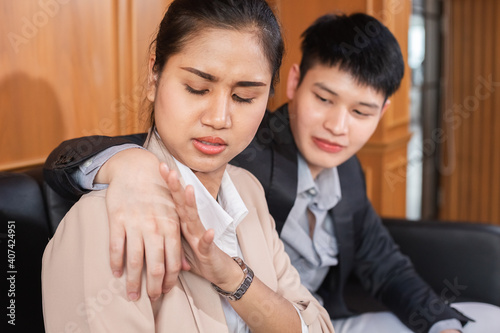 businesswoman push hand businessman off shoulder hers from trespass.