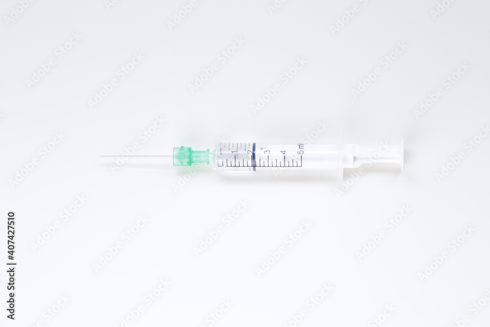 Syringe with fluid against white background Syringe with fluid against white background
