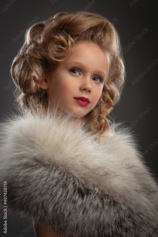 portrait of a beautiful little blonde girl with jewelry and stylish hairstyle dressed in a white dress and a fur coat portrait of a beautiful little blonde girl with jewelry and stylish hairstyle dressed in a white dress and a fur coat