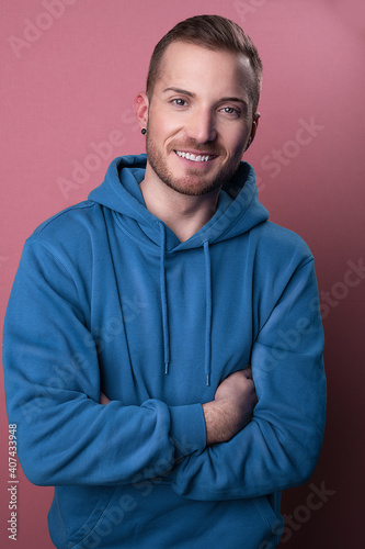 carefree pleasant millennial stand in front of camera with crossed arms and smile happily at camera while being open mindend and cheerful © Shotmedia