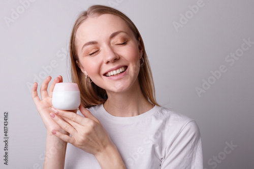 Girl smiling with cream in hand