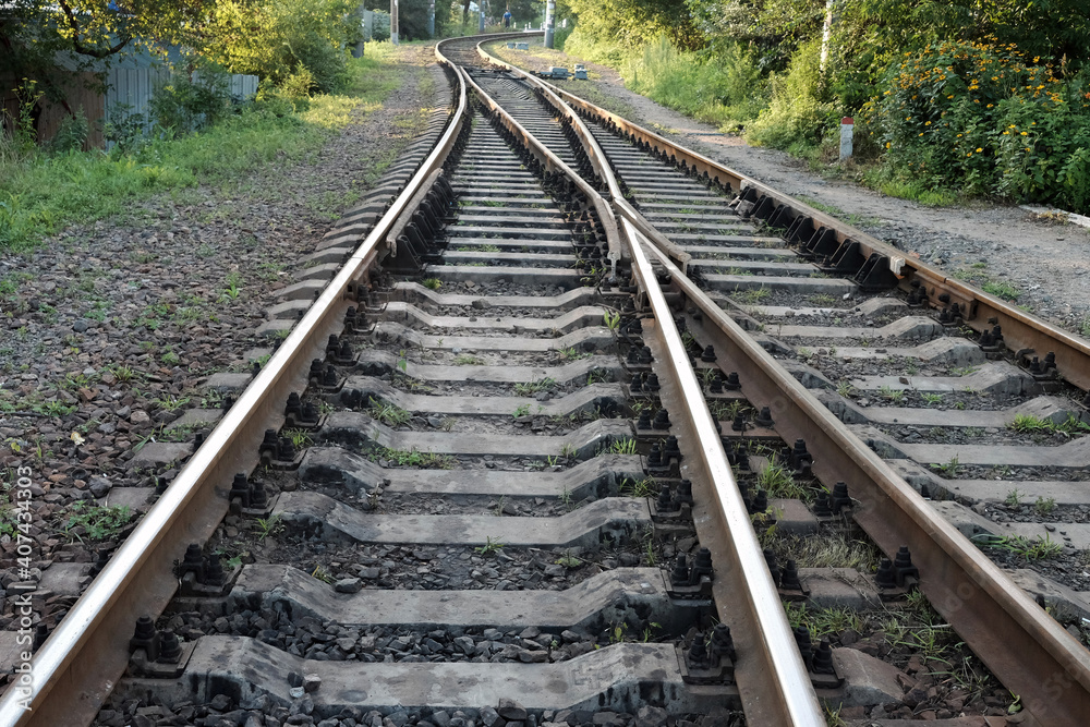 Fragment of a railway track with rails and sleepers in the countryside