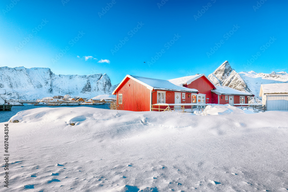 Traditional Norwegian red wooden houses on the shore of  Reinefjorden on Toppoya island