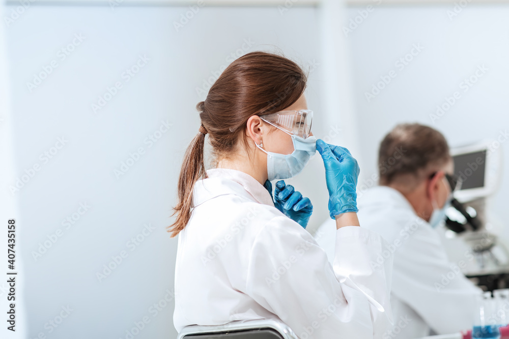 close up. female scientist sitting at a laboratory table. close up. female scientist sitting at a laboratory table.