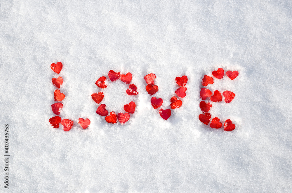 valentine's day concept: word love laid out with hearts on snow valentine's day concept: word love laid out with hearts on snow