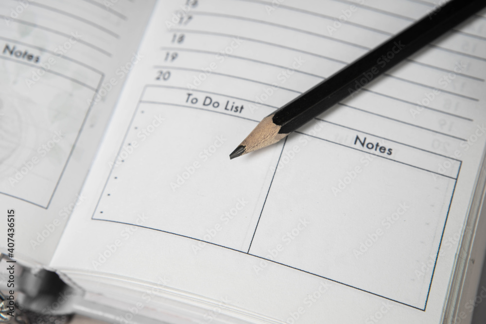 Pencil on opened diary notebook. Empty To do list and Notes. Close-up. Pencil on opened diary notebook. Empty To do list and Notes. Close-up.