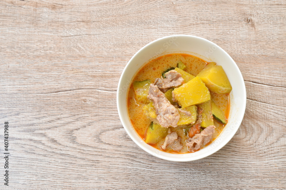 spicy boiled pumpkin with slice pork in curry on bowl