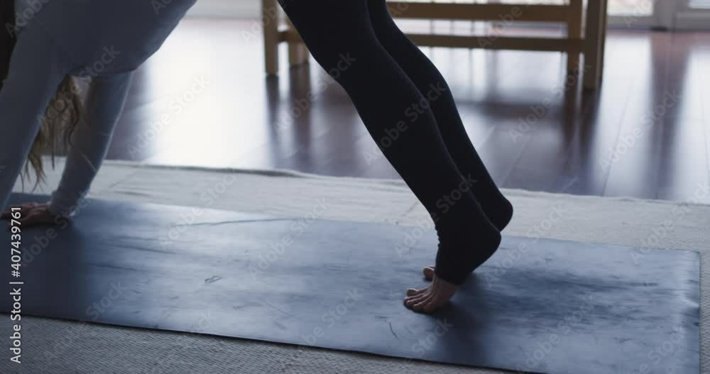 Slow-motion female doing yoga in her home Slow-motion female doing yoga in her home