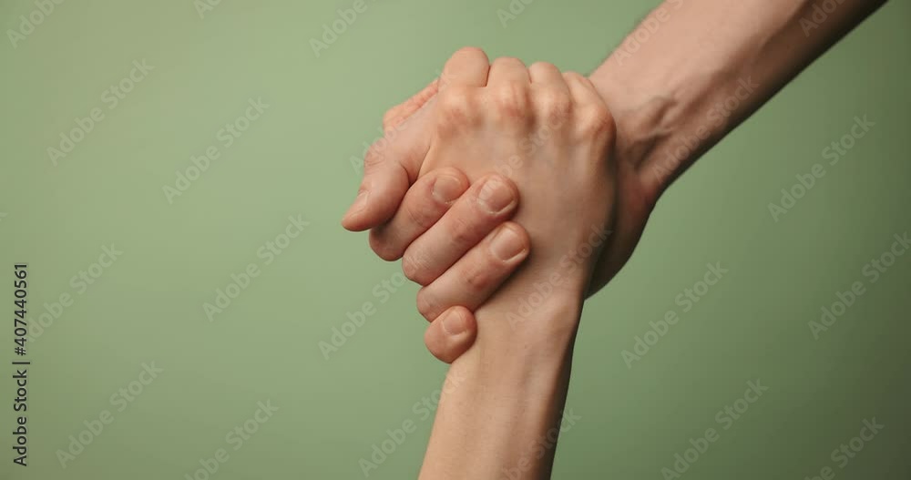help friend through a tough time. rescue gesture. hands reaching together on green background