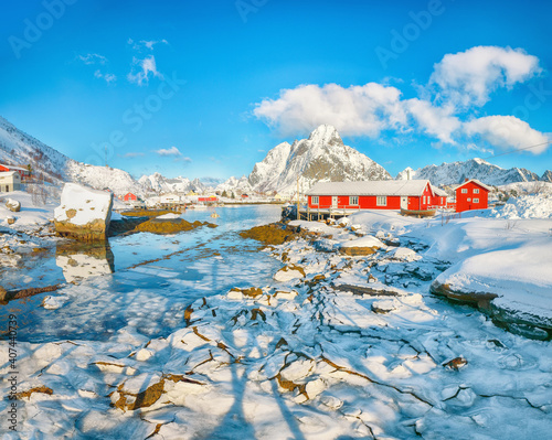 Breathtaking winter sunny view on Reine Village and Gravdalbukta bay with cracked ice.