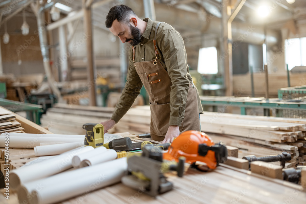 Handsome carpentry worker in the joinery manufacturing Handsome carpentry worker in the joinery manufacturing