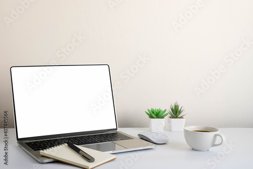 White office desk table with keyboard of laptop, coffee cup and notebook, mouse computer with equipment office supplies. Business and finance concept. Workplace, Flat lay with blank copy space.