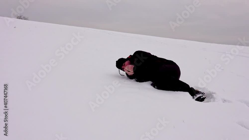 Hiker, tired, alone, fallen in the snow, trembling. Hypothermia