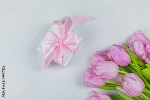 Gift box with ribbon, bouquet of pink tulips on a white background. Mothers Day. International Women's Day. Holidays. © Kristina89