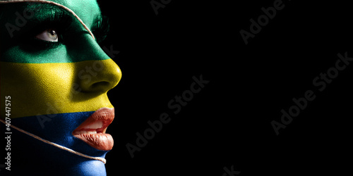 Gabon flag painted on a face of a young woman, national flag photo