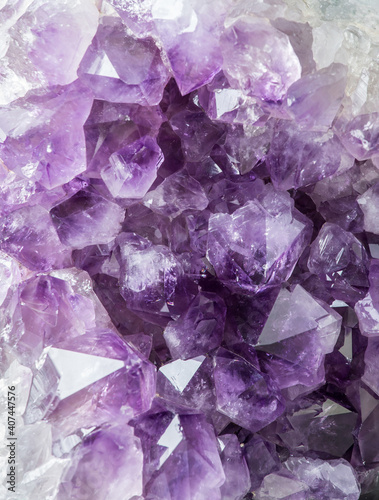 Close up view of large violet amethyst crystal cluster. Esoteric magical background concept.