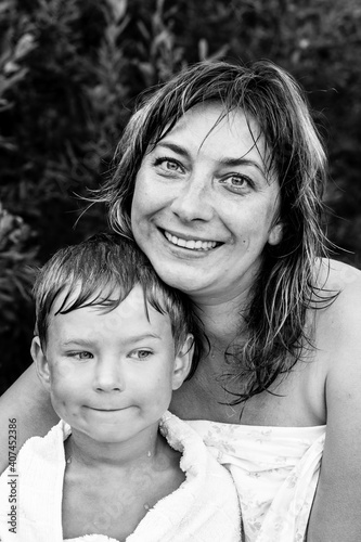 Happy woman and her little son after bathing. Black and white photo.