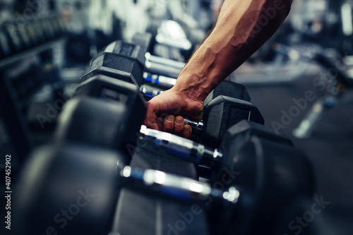 Rows of dumbbells in the gym with hand © zorandim75