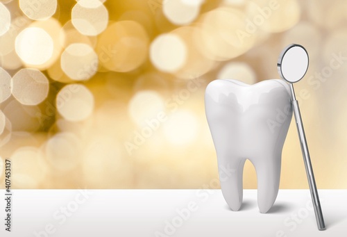 Big tooth and dentist mirror in dentist clinic on bokeh background