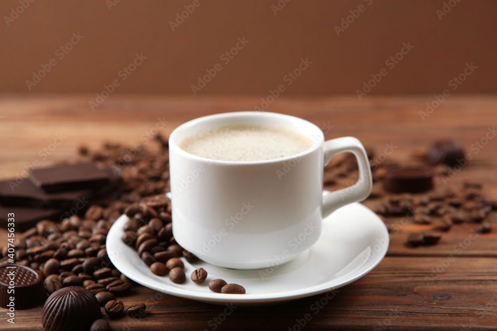 cup of coffee, coffee beans and chocolate on the table close up cup of coffee, coffee beans and chocolate on the table close up